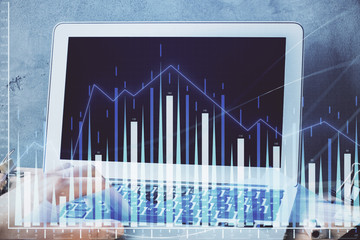 Forex graph with businessman working on laptop on background. Concept of hardworking. Multi...