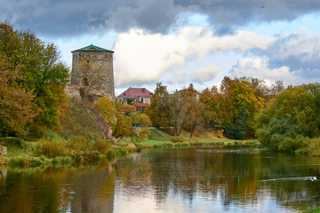 Fototapeta na wymiar Autumn landscape. View of the river and the old fortress.