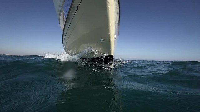 Sailboat prow sailing closeup in super slow motion, loopable
