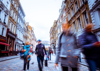 Fototapeta premium Motion blurred people walking on shopping street