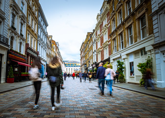 Motion blurred people walking on shopping street