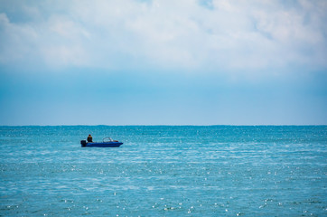A fisherman is sailing in a boat.
