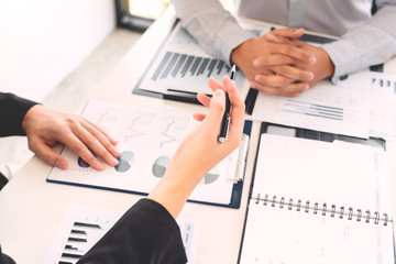 Business Corporate team brainstorming, Planning Strategy having a discussion Analysis investment researching with chart at office his desk documents and saving concept