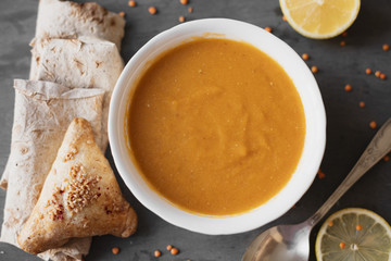 Flat lay indian soup with lemon and pita