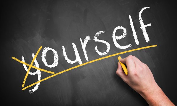 hand crosses a letter on chalkboard, making the word "yourself" to "ourself"