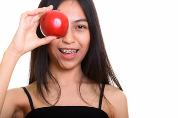 Young happy Asian teenage girl smiling while covering eye with r