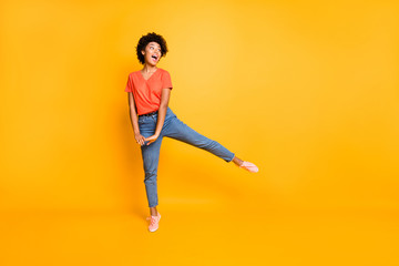 Fototapeta na wymiar Full length body size photo of cheerful cute nice rejoicing overjoyed african youngster seeing her favorite goods discounted wearing jeans denim sneakers isolated vivid color background