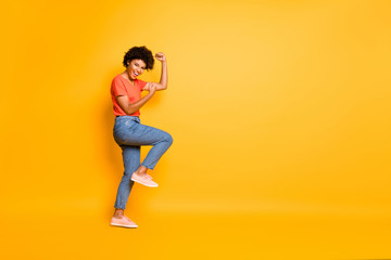 Fototapeta na wymiar Copyspace photo of charming cheerful cute attractive nice pretty girlfriend wearing jeans denim t-shirt rejoicing with victorious glory isolated over yellow vivid color background