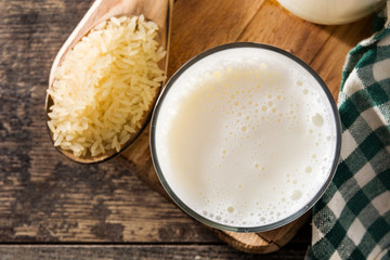 Rice milk in glass on wooden table. Top view