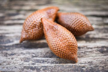 Salak on wooden background - Salak tropical fruit Salacca zalacca or Snake fruit palm