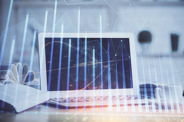 Forex Chart hologram on table with computer background. Multi exposure. Concept of financial markets.