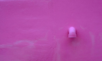 Pink concrete with drainage pipe for background.