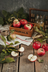 Harvest of red apples on wooden background