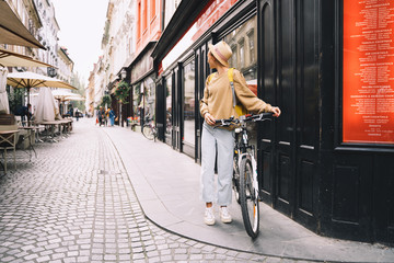 Girl with backpack and bicycle explores Ljubljana. Travel Slovenia