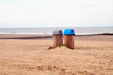 wooden garbage bins on the beach. Protecting the environment by recycling and throwing away...