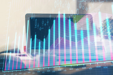 Forex market graph hologram and personal computer on background. Multi exposure. Concept of investment.