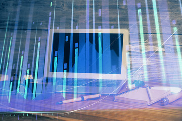 Financial graph colorful drawing and table with computer on background. Double exposure. Concept of international markets.