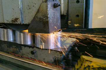 Naklejka na ściany i meble Flat grinding of metal on a machine with sparks, technological g