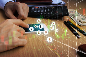 Businessman touch samrtphone network using currency icon technology with virtual screen icons, Investment Financial Technology