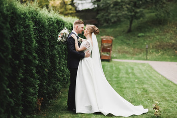 Happy wedding couple walking in a botanical park