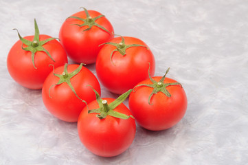 Red tomatoes on a marble background