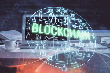 Multi exposure of blockchain theme hologram and table with computer background. Concept of bitcoin...