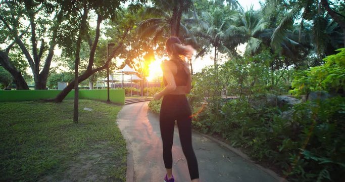 woman runing on the sun set in the park