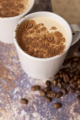 High view cup of coffee with cocoa powder