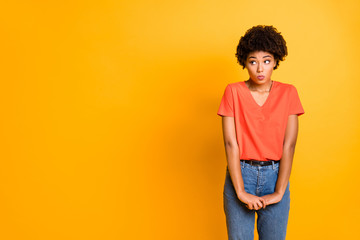 Copyspace photo of cute charming pretty girlfriend unconfident standing hesitating to ask something wearing jeans denim isolated over yellow vivid color background