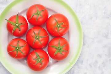 Red tomatoes on a marble background
