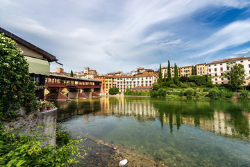 Fototapeta na wymiar Bassano del Grappa with the river Brenta and the Ponte degli Alpini (Bridge of the Alpini). Vicenza province, Veneto, Italy, Europe