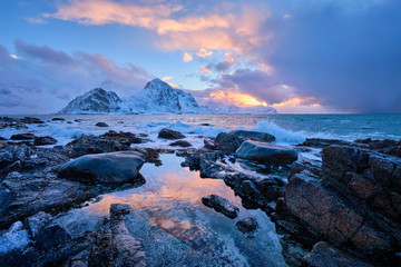 Coast of Norwegian sea on rocky coast in fjord on sunset