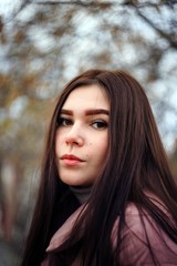 Naklejka premium Portrait of a beautiful plus size brunette with a blurred background.