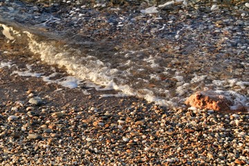 Rock textures, boulders and waves on the shore in Cartagena, Spain