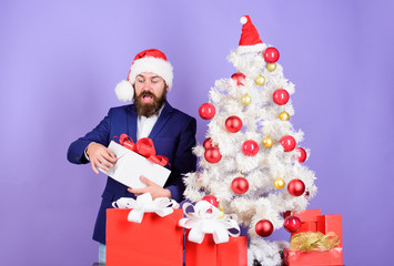 Office christmas party. Winter holidays. Christmas greetings. Best gifts shop. Man bearded hipster formal suit near christmas tree. Christmas gifts and decorations. Secret Santa concept. Buy present