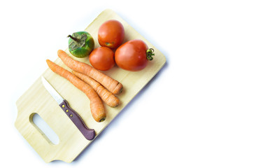 Carrot, Tomato, Eggplant, Knife and wooden cutting board isolated on white background.