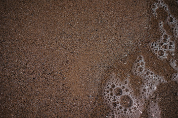 sea ​​water washes sand on the shore, top view