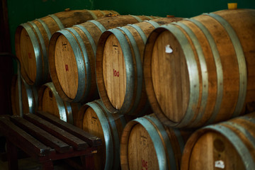 Wine barrels stacked in the old cellar of the winery.