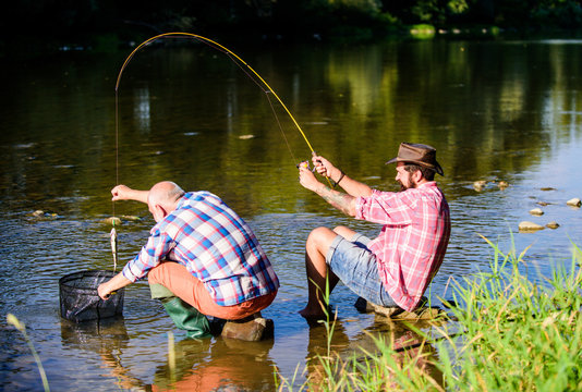 Black Market Caviar. Illegal Hunting Caviar. Extracts Eggs From Sturgeon Caught River. Trap For Fish. Men Sit At Riverside With Fishing Equipment. Poaching Crime And Fishing License. Poachers Fishing