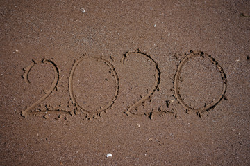 2020 written in beach sand