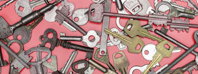 Keys set on pink background. Door lock keys and safes for proper