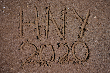 Fototapeta premium happy new year 2020 written in the sand