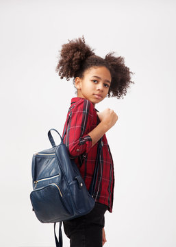 Cute smiley girl in chequered shirt with backpack