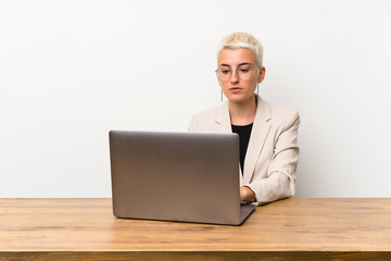 Teenager girl with short hair with a laptop