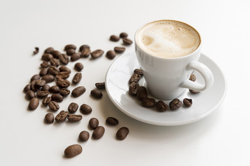 Cup of coffee with coffee beans
