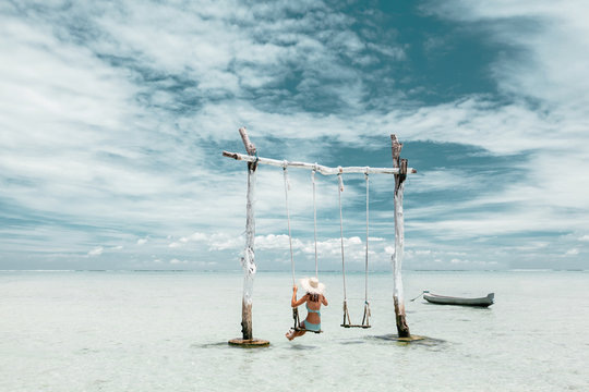 Girl On Beach Swing On Bali Island