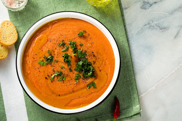 cream soup of red lentils with tomatoes on the table. healthy vegan warming food for the whole family