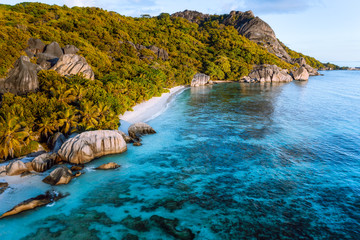 Golden hour at Anse Source D Argent exotic beach at Seychelles. Aerial drone photo from above