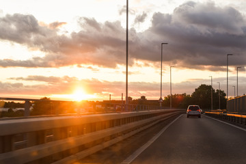 Driving at sunset view from inside vehicle with traffic ahead
