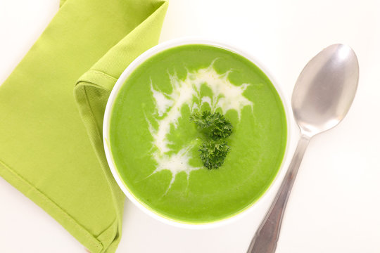 Bowl Of Green Soup And Cream, Top View